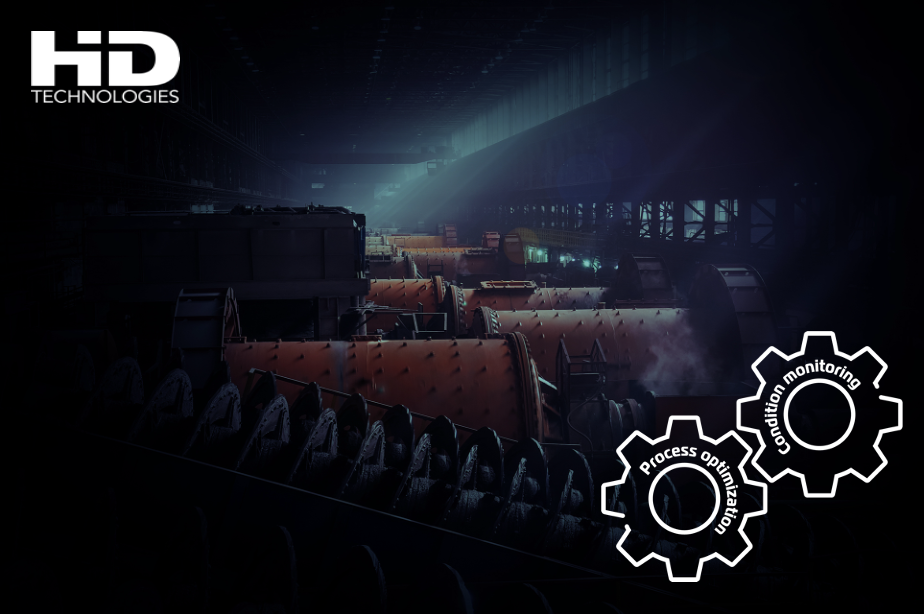 Industrial environment with tumbling mills, overlayed with a HD Technology logotype and two outlined gears